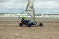 Beautiful shot of a person driving blokart on the sandy beach