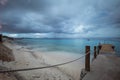 Beautiful shot of a pier leading to the ocean under the gloomy sky in Bonaire, Caribbean Royalty Free Stock Photo