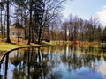 Beautiful shot of the pond with trees and arbor on its shore in Jelenia GÃÂ³ra, Poland.