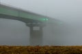 Beautiful shot of a road bridge disappears into the fog across the Missouri river in Kansas City