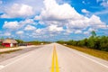 Beautiful shot of a road from the everglades on a sunny day under the blue sky in Miami, USA Royalty Free Stock Photo