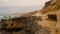 Beautiful shot of rocky coastal cliffs on a cloudy day Royalty Free Stock Photo