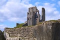 Beautiful shot of the ruins of Corfe Castle under blue sky and white clouds Royalty Free Stock Photo