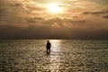 Beautiful shot of a silhouette of a paddleboarder on a lake at sunset Royalty Free Stock Photo