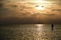 Beautiful shot of a silhouette of a paddleboarder on a lake at sunset Royalty Free Stock Photo