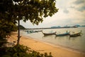 Beautiful shot of small boats in the sea next to the shore on a cloudy day Royalty Free Stock Photo