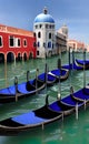 Beautiful shot of small gondolas in the river with buildings of Venice in the background