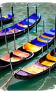 Beautiful shot of small gondolas in the river with buildings of Venice in the background