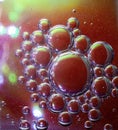 Beautiful shot of soap bubbles with interesting textures on a red background Royalty Free Stock Photo