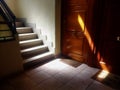 Beautiful shot of the stairs of a building and the sun shining on a part of the wooden doors Royalty Free Stock Photo