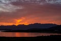 Beautiful shot of a sunset over a lake and mountains Royalty Free Stock Photo