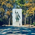 Beautiful shot of Theodore Roosevelt statue on Roosevelt Island with colorful trees Royalty Free Stock Photo