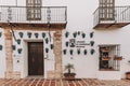 Beautiful shot of traditional house decorated with window flower boxes in Ronda Andalusia Spain