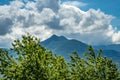 Beautiful shot of the trees in front of the mountains on the path to the giant bench in Rogno Royalty Free Stock Photo