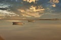 Beautiful shot of two boats on a reflective lake surface during a sunset