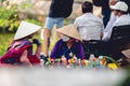 Beautiful shot of two women selling things in the local native market in Hanoi City, Vietnam