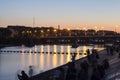 Beautiful shot of a walking area in a city with a lake and the reflection of the street lights