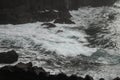 Beautiful shot of the waves of a lake crashing on the rocks near the shore Royalty Free Stock Photo