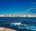 Beautiful shot of a wavy sea with buildings on the background in Coruna Galicia Spain Royalty Free Stock Photo
