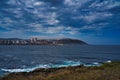 Beautiful shot of a wavy sea with buildings on the background in Coruna Galicia Spain Royalty Free Stock Photo