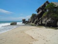 Beautiful shot of a white sand beach with a house on the rocky cliff Royalty Free Stock Photo