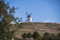 Beautiful shot of white windmills in the field under a blue sky Royalty Free Stock Photo