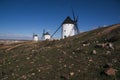 Beautiful shot of white windmills in the field under a blue sky Royalty Free Stock Photo
