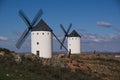 Beautiful shot of white windmills in the field under a blue sky Royalty Free Stock Photo