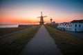 Beautiful shot of a windmill by the sea under the sunset captured in Vlissingen, Netherlands