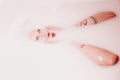 Beautiful shot of a woman lying in the bathtub with white soupy water