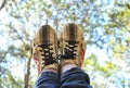 Beautiful shot of the woman sneakers with the trees and the sky in the background Royalty Free Stock Photo