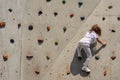 Beautiful shot of a young girl climbing a wall with boulders Royalty Free Stock Photo