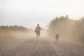 Beautiful shot of a young male running in nature with his dog Royalty Free Stock Photo