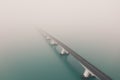 Beautiful shot of the Zeeland bridge covered with fog in the Netherlands Royalty Free Stock Photo