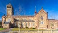 Beautiful side view of a church with its clock in a tower and multiple windows