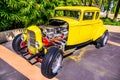 Beautiful side view of an 1932 Ford 5 Window Coupe Street Rod antique yellow car