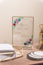 Beautiful sign next to a stack of envelopes for writing names and addresses of the guests