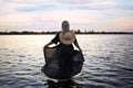 Beautiful silhouette of a Caucasian girl in a black pareo at the sea Royalty Free Stock Photo