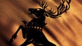 Beautiful silhouette of the deer standing on its hind hooves on golden waving flag background, seamless loop. Baratheon