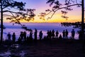 Beautiful Silhouette of hiker or traveler enjoy mist and sunrise at Nok Aen Cliff, Phu of Kradueng national park, Loei, Thailand