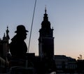 Beautiful silhouette of horse-drawn carriage coachman with in the background the old town of Krakow, Poland