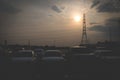 A beautiful silhouette image of many cars parked in an outdoor parking lot, with the backdrop of the sky in the evening. Royalty Free Stock Photo