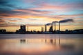 Beautiful silhouette of an industrial factory across the water at sunset in Aalbor, Denmark