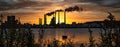 Beautiful silhouette of an industrial factory across the water at sunset in Aalbor, Denmark