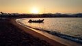 Beautiful silhouette of inflatable motor boat waving on the calm sea waves aginst sunset sky Royalty Free Stock Photo