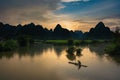 Beautiful silhouette mountains with fisherman and green rice field and river pass at the Phong Nam village in Cao Bang, Vietnam Royalty Free Stock Photo