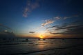 Beautiful silhouette of ship and long tail boat on sea or ocean with blue sky and cloud at sunset, sunrise or twilight light Royalty Free Stock Photo