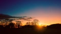 Beautiful silhouette of trees at a park against a sunset sky Royalty Free Stock Photo