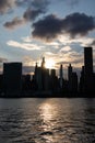 Beautiful Silhouettes of Skyscrapers in the Midtown Manhattan Skyline during a Sunset along the East River in New York City Royalty Free Stock Photo