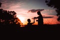 Beautiful silhouettes of two dancers at sunset. silhouette of brother and sister dancing at sunset